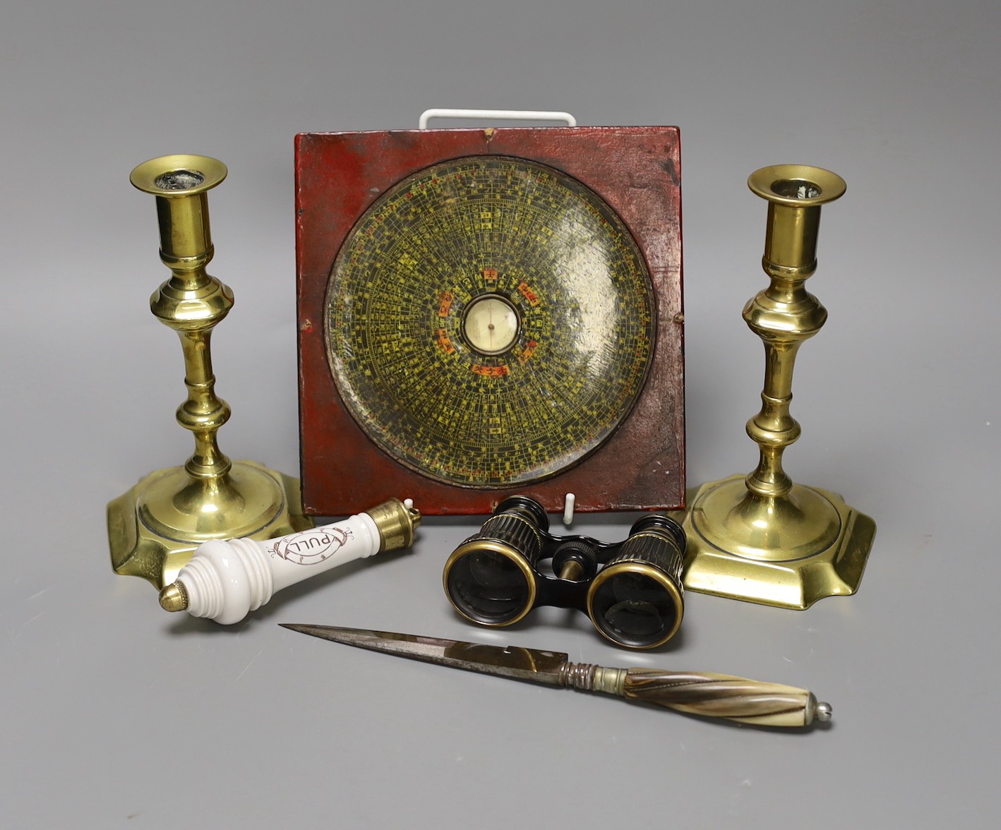 A pair of George III brass candlesticks, southern European knife, a pair of opera glasses, lavatory pull and a Chinese feng shui compass (6)